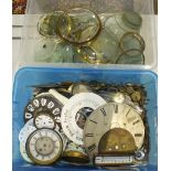 A collection of clock pendulums, clock dials, bezels, etc.