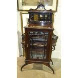 An Edwardian walnut display cabinet with mirrored back, glazed door and splayed legs, 80cm wide,