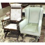 An American stained wood rocking chair with upholstered back, seat and arms and an Edwardian