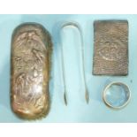 A pair of silver sugar tongs, London 1806, a silver napkin ring, a silver back prayer book and a