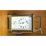 A Continental brass carriage clock, the dial with Roman numerals and subsidiary alarm dial, the