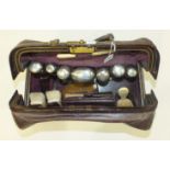 A gentleman's fitted leather travelling case, The Gladstone, opening to reveal a collection of