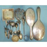 A white metal-framed hand mirror and hairbrush, both stamped Wingon Co.H.K, a silver sifter spoon,