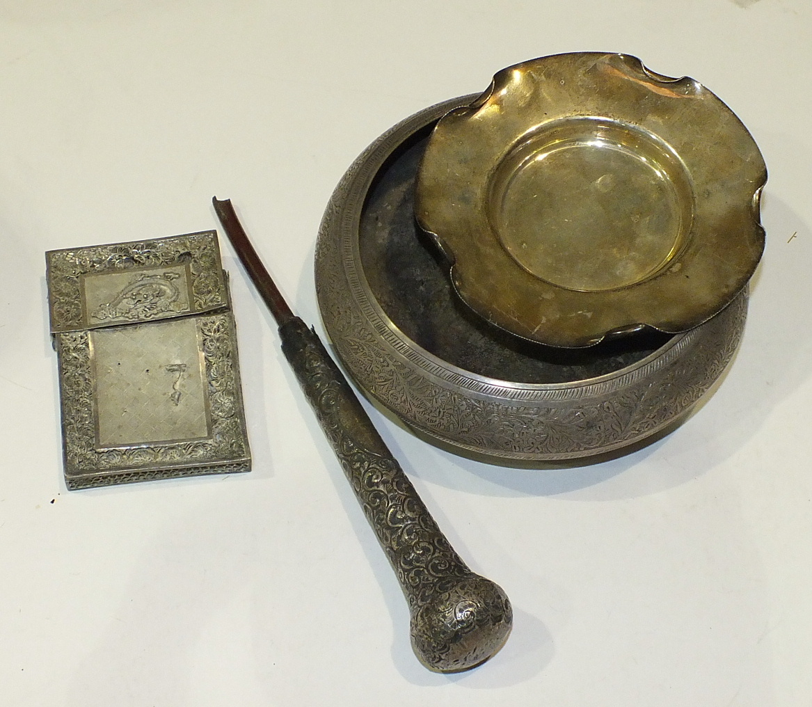 An Indian white metal bowl with leaf decorated border, 16cm diameter and other items.