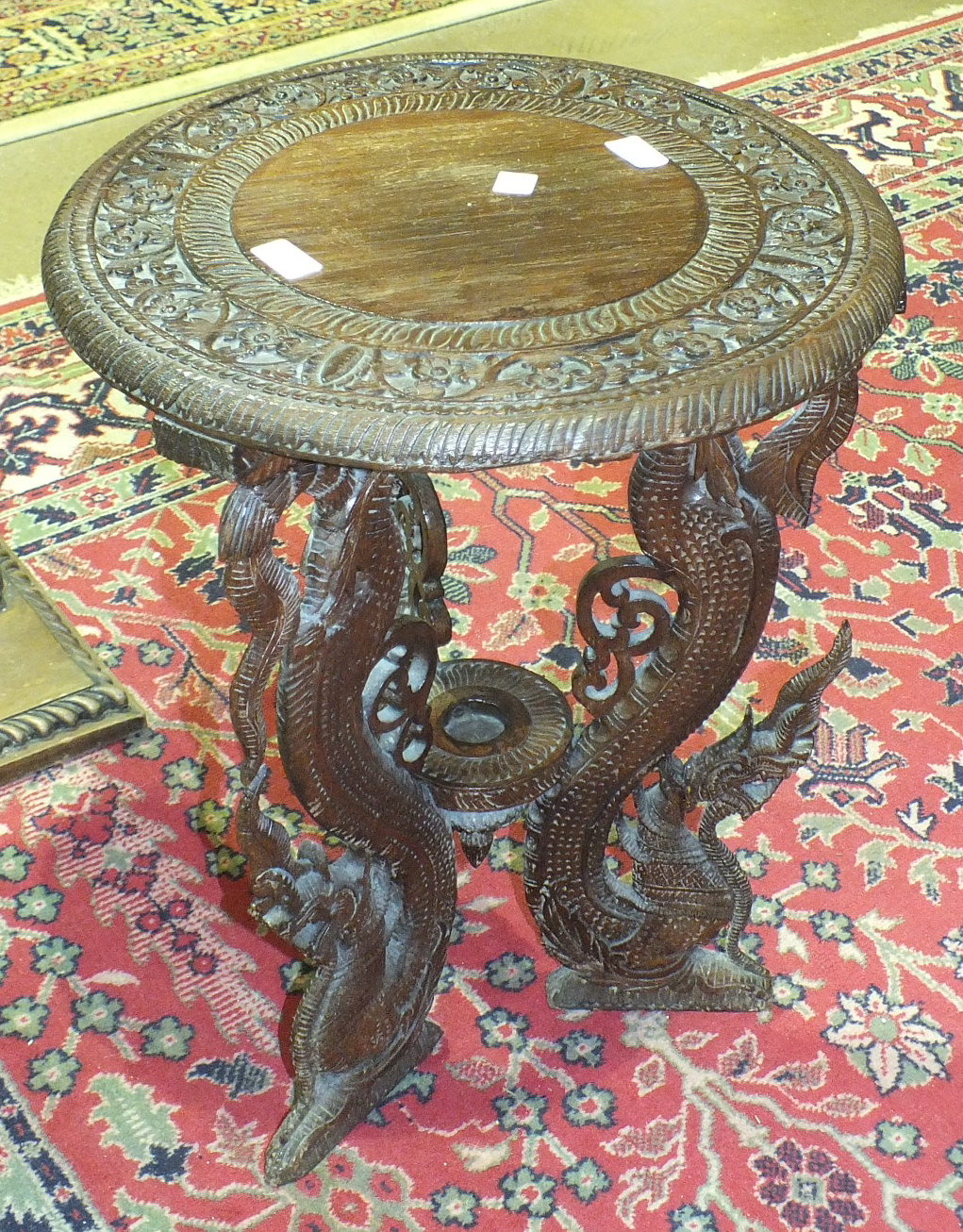 An oriental carved wood circular occasional table, 45cm diameter.