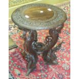 An oriental carved wood circular occasional table, 45cm diameter.