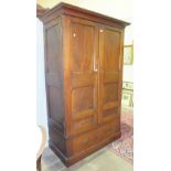 A hardwood panelled two-door wardrobe, 134cm wide, 213cm high.