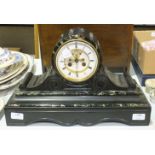 A black slate and green marble striking drum mantel clock, the white chapter ring enclosing a