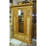 A satin walnut wardrobe, the cornice above a single mirrored door, on drawer base, 125cm wide, and a