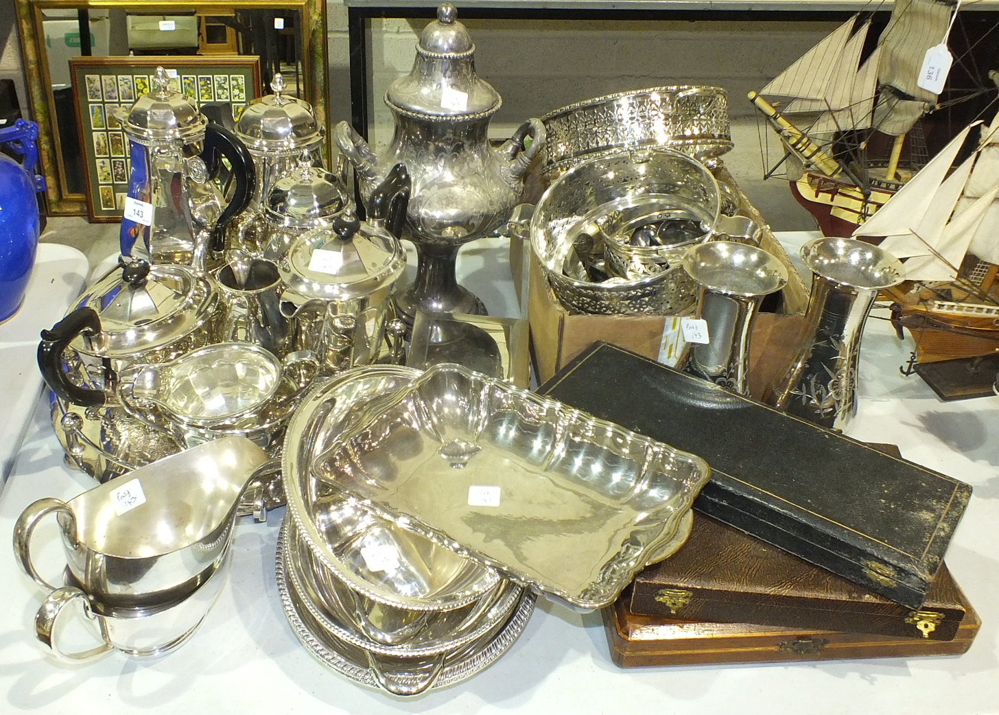 A five-piece plated tea service, an oval galleried tray, plated cutlery, two entrée dishes and