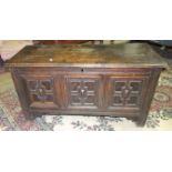 An antique panelled oak coffer, the front with geometric designs, 140cm wide.