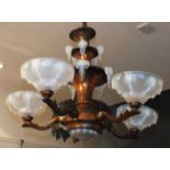An early-20th century lacquered copper four-branch chandelier with tiered opaque glass icicles and