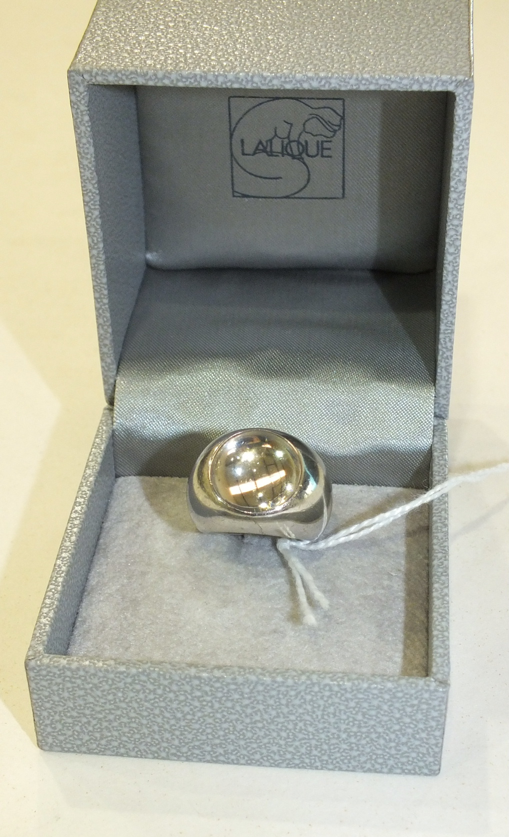 Lalique, a boxed silver ring set a clear glass cabochon, size J.