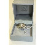 Lalique, a boxed silver ring set a clear glass cabochon, size J.