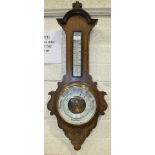 An inlaid mahogany aneroid barometer/thermometer, 32cm wide, 86cm high.