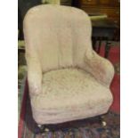 A Victorian upholstered salon chair on short turned walnut legs.