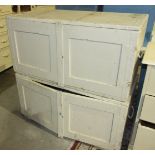 Two metal-bound painted wood two-door cupboards and metal carrying handles, 105cm wide.