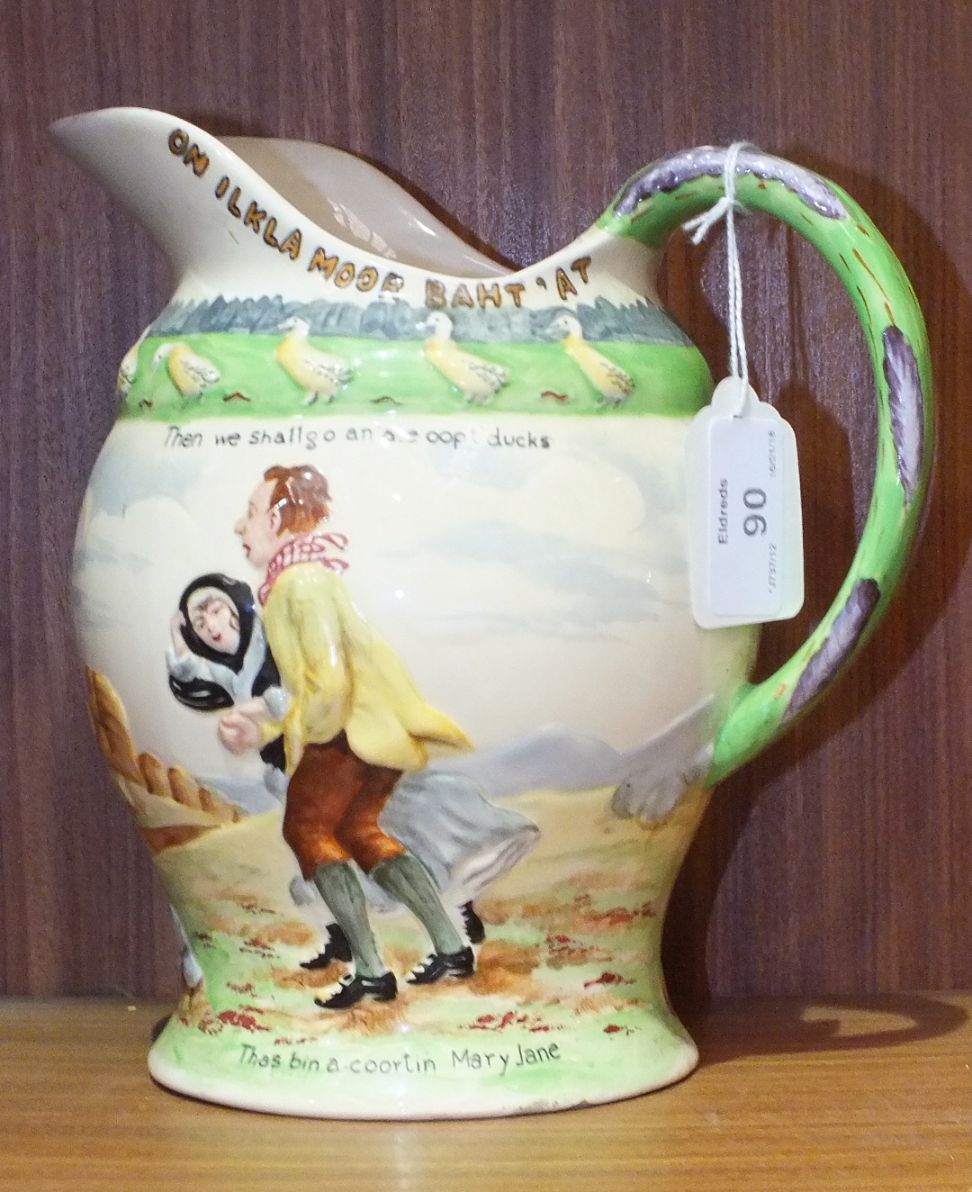 A Fieldings Crown Devon On Ilkla Moor Baht'At musical jug, 19.5cm high.