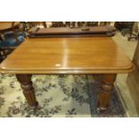 A late-19th century mahogany extending dining table on fluted legs with two extra small leaves and