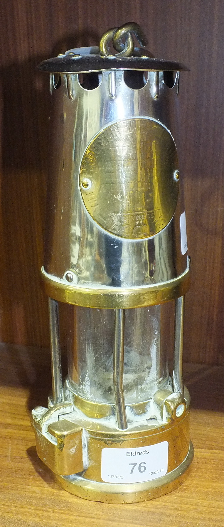 An early-20th century Protector Lamp and Lighting Company brass and metal miner's lamp, 25cm high.