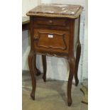 A French pot cabinet, with marble top above a small drawer and cupboard door opening to reveal a