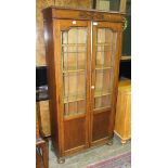 An oak bookcase fitted with a pair of leaded-light doors, 76cm wide, 159cm high.