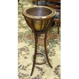 An early-20th century mahogany jardinière stand, the flared basket-pattern top with moulded rim