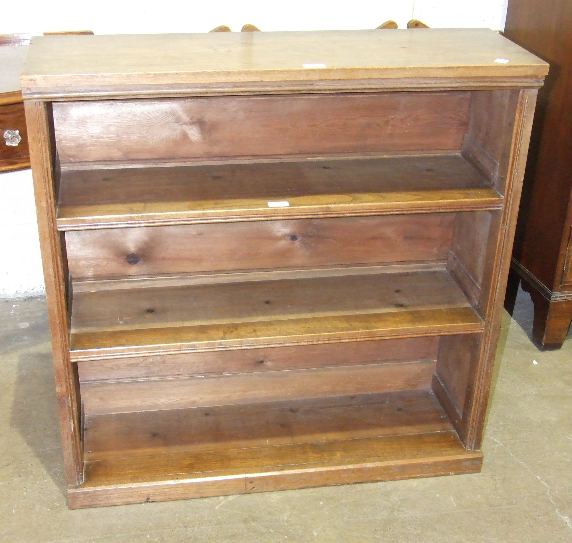 A walnut freestanding open bookcase, 91cm wide, 93cm high, 30cm deep.