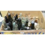 A collection of various glass mineral and medicine bottles, a pair of carved wood elephant bookends,