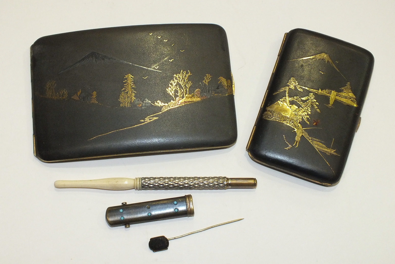 A Japanese black-lacquered metal cigarette case decorated with landscape and figure, 8 x 12cm, a