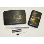 A Japanese black-lacquered metal cigarette case decorated with landscape and figure, 8 x 12cm, a