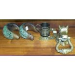 A 20th century brass horses head door knocker, two African pierced metal armlets and a plated
