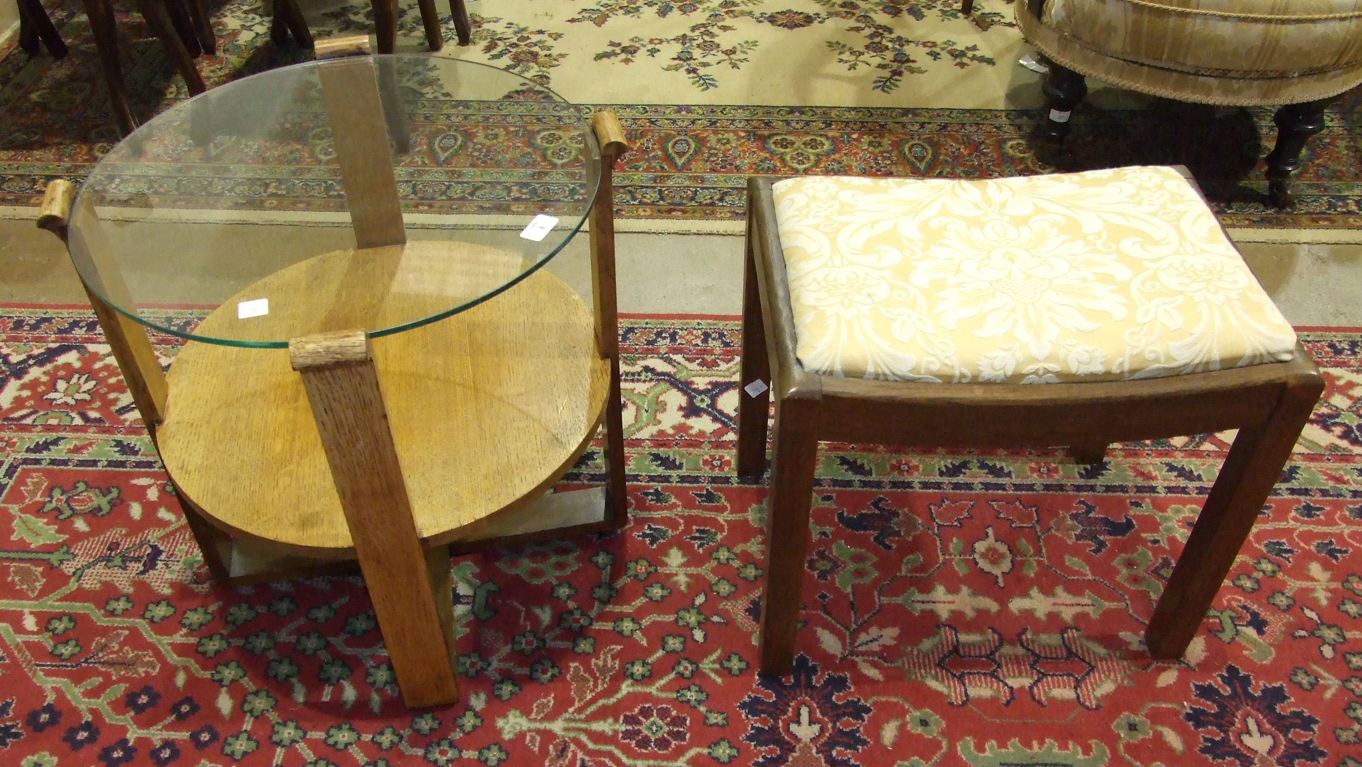 A 1950's/60's oak circular occasional table with plate glass top, the supports joined by an