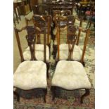 Three Victorian walnut dining chairs, each with shaped back, carved centre bar, drop-in seats, on