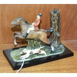 A 20th century painted spelter match strike in the form of a huntsman and hound, 11cm high, 15cm