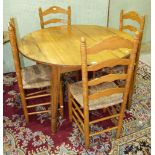 A pine circular table on square tapered splayed legs, 119.5cm diameter and a set of four pine