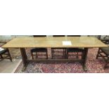 An oak refectory-style narrow dining table, the rectangular top on tapered end supports united by