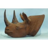 A resin cast of a taxidermy rhino head with inset eyes, eyelashes, etc, 95cm long, 67cm wide.