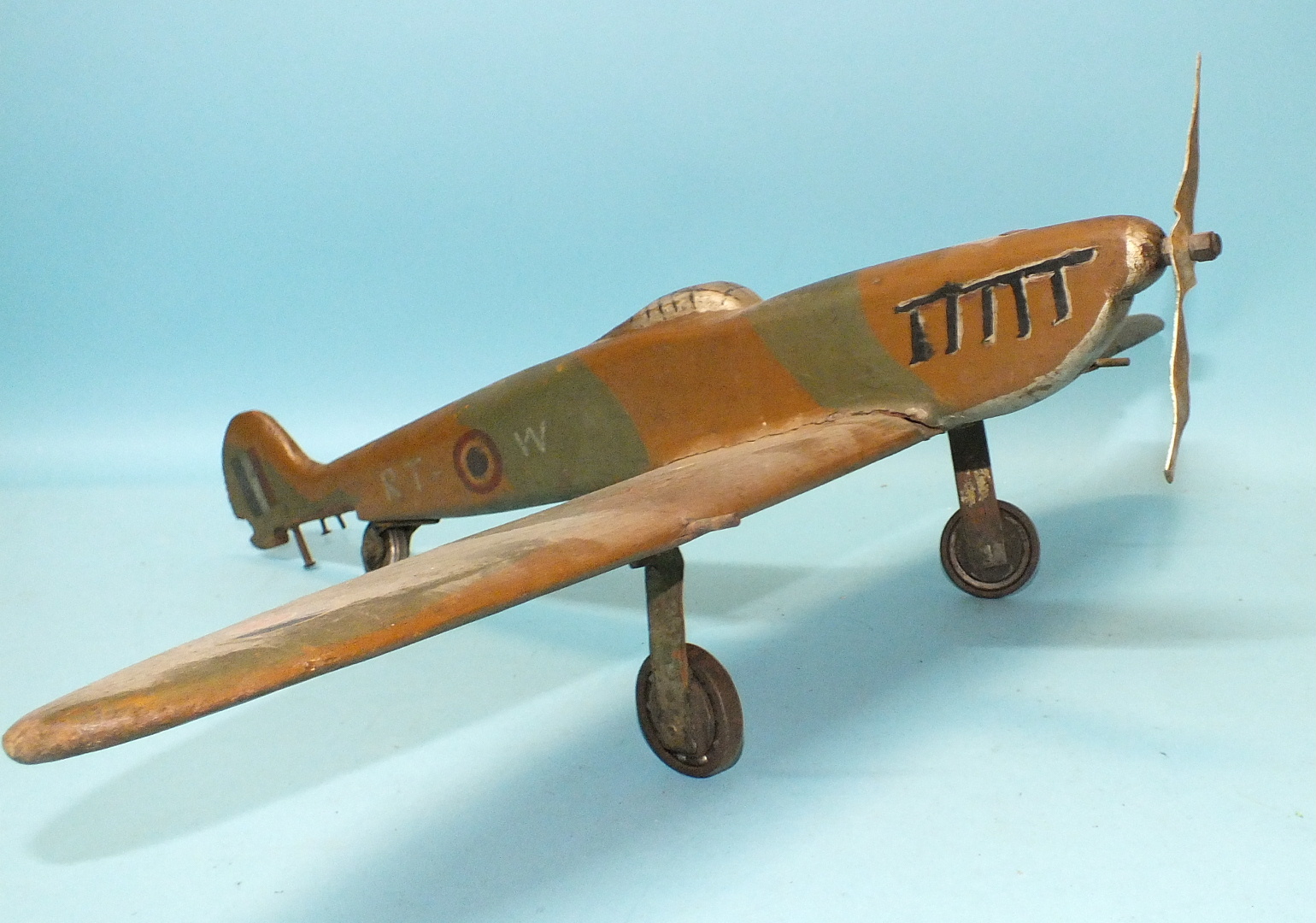 A scratch-built wooden model of a WWII Spitfire, (horizontal tail stabiliser missing), 47cm long.