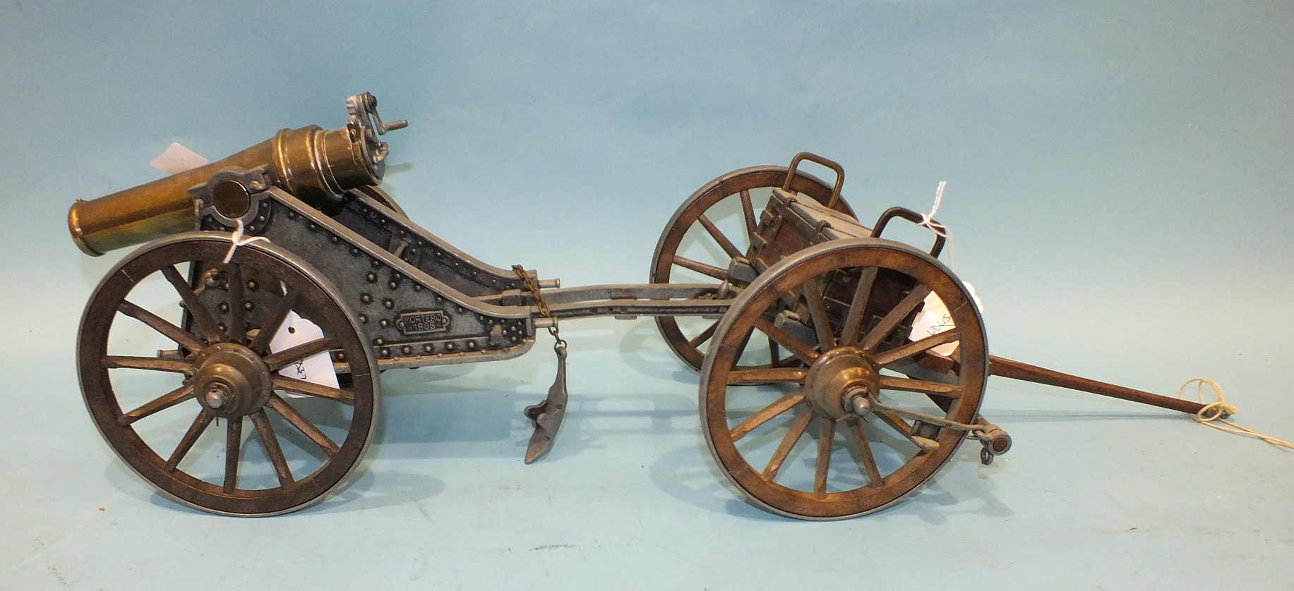 A 20th century cast metal and brass model of an 1895 Mortero canon stamped '3001' to barrel, 33cm