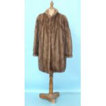 A Hickleys labelled light brown mink coat with stand-up collar and wide sleeves gathered at the