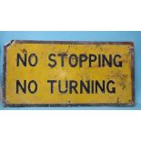 A yellow and black enamel road sign, "No Stopping No Turning", 51 x 100.5cm, (a/f, one corner