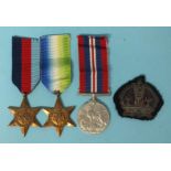 A WWII group of three medals: Atlantic Star, 1939-45 Star and War Medal, with a crown cloth badge.