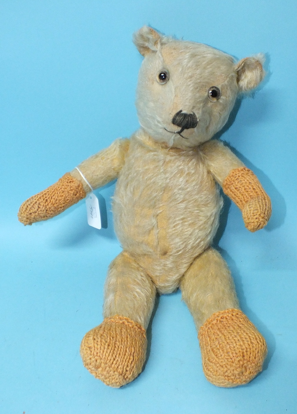 A teddy bear c1940's, possibly a Chiltern Hugmee, with clear and black glass eyes, vertically-