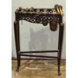 A xylophone of six graduated brass bells, on stained wood stand, 58cm long, 80cm high.
