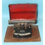 A 'Frolio 5' typewriter with lacquered metal cover.