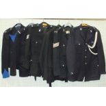 A large quantity of Police uniforms, to include tunics, cloaks, great coats and a wooden truncheon.