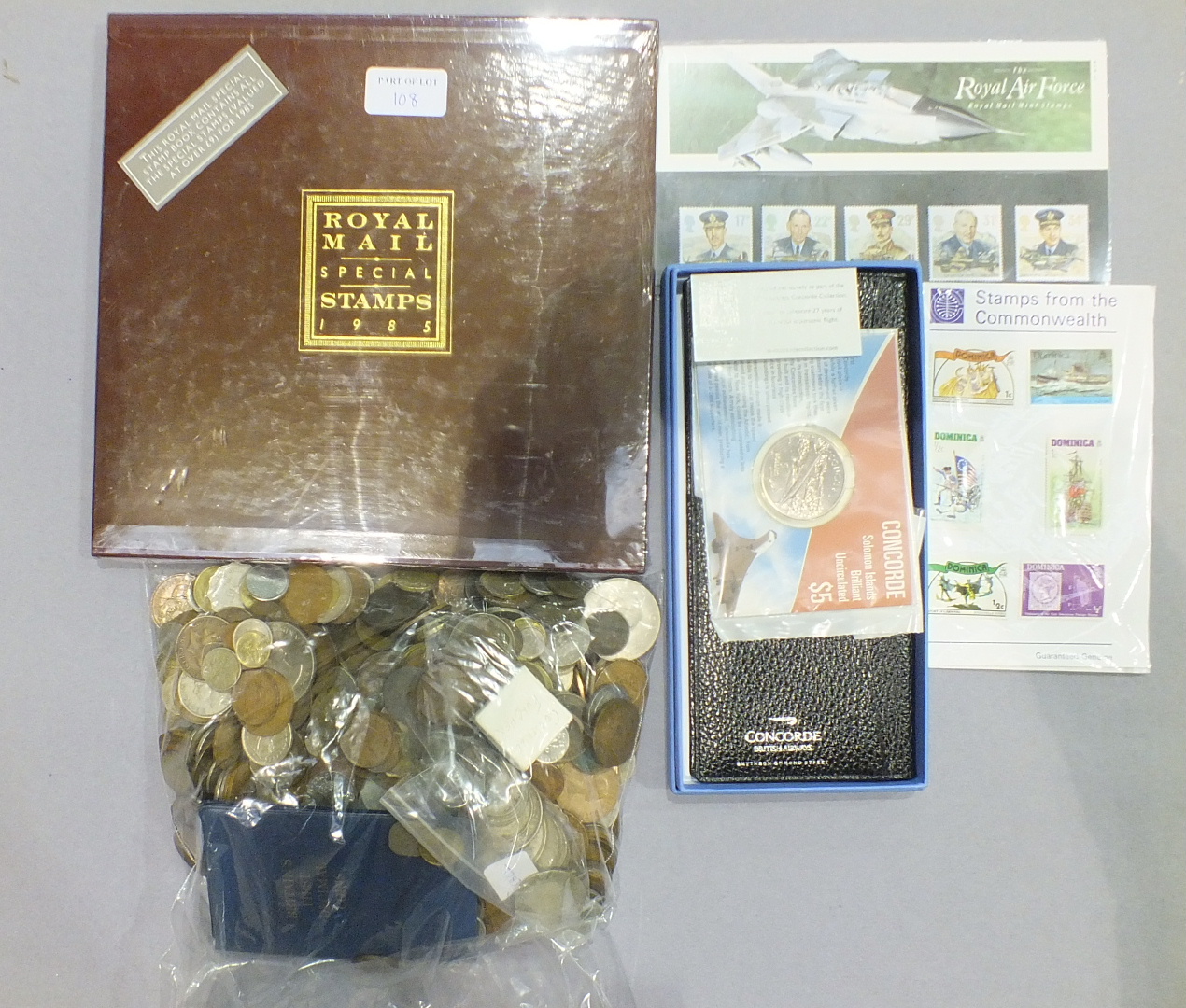 A collection of mainly foreign coinage, (includes silver coins), a Royal Mail special stamp book for