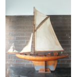 An early-20th century pond yacht with wooden hull and deck, weighted keel, gaff-rigged, 104cm.