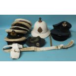 A Royal Marines helmet and belt, five Royal Navy caps, two RAF caps, a beret, a German Ensign flag